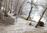 A hiker walks along White River on trail 5 at Mounds State Park. The construction of the proposed Mounds Lake reservoir would flood this part of the trail. Staff photo by John P. Cleary