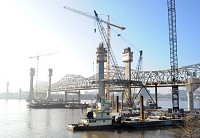 Construction of the Ohio River Bridges Project downtown crossing reaches another milestone as Walsh Construction crews begin setting the first of the stay cables and structural steel recently. You can take a virtual tour of construction by visiting seethebridge.com or kyinbridges.com. Staff file photo