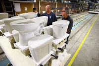 CLOSER LOOK: Owner Dow Dillinger and engineer Jeff Dick inspect the bowls of the first toilets produced in the&nbsp;continuous run kiln Sept. 15, 2014, at Patriot Porcelain. Staff photo by Tim Bath