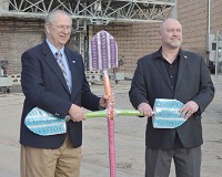 Former Michigan City mayor Chuck Oberlie, at left, and Mayor Ron Meer&nbsp;use shovels with artistic designs to break ground on the new Artspace Uptown Artist Lofts on Friday. Staff photo by Richard Chambers