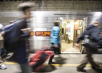 Passengers exit Millennium Station after riding on the South Shore's inaugural run of the Sunrise Express on Monday, March 16, 2015, in Chicago. SBT Photo/ROBERT FRANKLIN