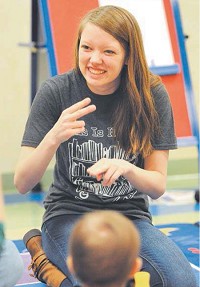 Hancock County Children&rsquo;s librarian Sara Cloyd demonstrates a phrase in sign language to non-hearing impaired toddlers during Saturday morning&rsquo;s class. The class was introduced to a couple of basic phrases on how to sign. Its hope is to help enhance communication with their infants. (Tom Russo | Daily Reporter)