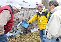 Members from a coalition of environmental groups headed up by Heart of the River look over a large map of the proposed reservoir with marked areas of "red flag" concerns about the project. Staff photo by John P. Cleary