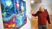 Curator Gregg Hertzlieb speaks about Magic Serpents, a painting by artist Anderson Debernardi, on Tuesday, March 24, 2015, as he walks through "Inner Visions - Sacred Plants, Art, and Spirituality", a new exhibit at the Brauer Museum of Art. (Kyle Telechan/For the Post Tribune)