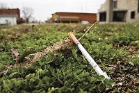 Sign of the times: A syringe is pictured along West Main Street in downtown Austin in Scott County on Tuesday afternoon. A recent outbreak of HIV infections in the county has been traced by health officials to intravenous drug use in the area, and a team with the Centers for Disease Control and Prevention is currently working with local officials to contain the outbreak. Staff photo by Christopher Fryer