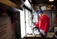 TJ Bollman, a sophomore at Indiana University, waits for customers in the food truck for The Big Cheeze last year. Matthew Hatcher | Herald-Times