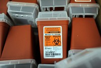 Medical waste containers are stored in preparation for Scott County residents that are looking to exchange used needles at the Community Outreach Center in Austin as part of the needle exchange program authorized by Gov. Pence. "The goal is a clean syringe for each injection use," said Brittany Combs, Scott County Public Health Nurse. Staff photo by Tyler Stewart