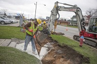 Rieth-Riley Construction Co. employee Joe Wolf, on Friday, works on inching out a slab of sidewalk as a contractor works on the Lincoln Way West Corridor improvements in South Bend. SBT Photo/SANTIAGO FLORES