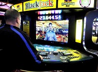 Josh Jones of Muncie plays blackjack against the video dealer at one of the 19 electronic table games inside Hoosier Park Racing &amp; Casino. Staff photo by John P. Cleary