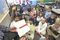 Students in Joe Brookshire&rsquo;s third-grade class ask questions during class at Kennedy Primary Academy in South Bend. The state on Friday released results of the IREAD tests taken by third-graders. SBT Photo/SANTIAGO FLORES