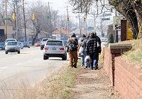 A group of homeless individuals carry belongings with them as they make their way down 10th Street to their camp in Jeffersonville. A new LifeSpring health clinic funded with federal grant money will target helping the homeless. Staff photo by Tyler Stewart