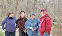 Heinzerling siblings Katrina Custer, Gretel Smith, Johanna Gordon-Byanksi and Derek Heinzerling reunited recently to share memories from the land now protected by ACRES Land Trust. Contributed photo