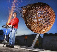 Thousands of steel rings welded together make up the massive sphere that is Logansport metal fabricator/artist James Galbreath&rsquo;s latest piece titled &ldquo;Meteor.&rdquo; Staff photo by J. Kyle Keener