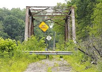 The bridge over Killbuck Creek on County Road 450 North will be replaced as part of a $2.2 million project. The steel bridge built in 1910 will be disassembled and delivered to the city of Anderson for a future as a pedestrian bridge. Staff photo by Don Knight