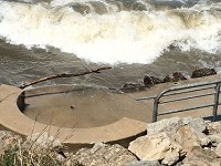 In previous years, the handicapped beach access walkway ended at a sandy beach. This summer, because of high lake levels and storms, the beach has been washed away. The access now drops off onto rocks and Lake Michigan. The access has been closed to the public. Staff photo by Joyce Russell