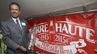 World famous: John S. Root holds an oversized replica of the famous Coca-Cola bottle designed in Terre Haute 100 years ago by the Root Glass Co. Staff photo by Jim Avelis