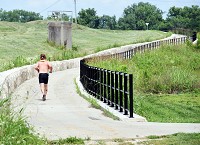 A runner makes his way up an incline while moving through a portion of the Ohio River Greenway in New Albany on Thursday. Staff photo by Tyler Stewart