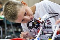 Huntingburg Elementary School fifth-grader Cameron Allen tested the arm of his robot during a STEM robotics camp last week at his school. Cameron said he decided to attend the robotics camp to help with his academic r&eacute;sum&eacute;. &ldquo;My mom said it would help with college,&rdquo; he said. &ldquo;I want to go to Purdue. Staff photo by Alisha Jucevic