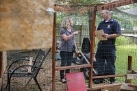Trisha Gooch, left, talks with animal control officer Jim Pritchard about her backyard chicken coop as he is inspecting it to renew the permit.&nbsp;Jeremy Hogan | Herald-Times