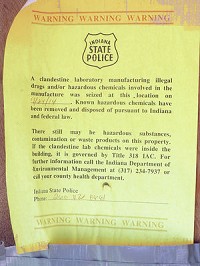An Indiana State Police notice is posted on a meth house in Kendallville that was busted in June, warning of potential contamination. Staff photo by Steve Garbacz