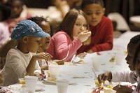 Children clean their plates during a meal at the Griffin Street/Kathy Wilkerson Recreation Center in this file photo. The city parks and recreation department fed the children during their Snack Attack program. Staff photo by Jerod Clapp