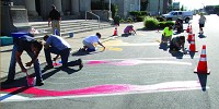 Shelbyville city department heads paint the parking spaces in front of City Hall Wednesday morning.