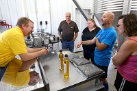 Mark Boyer (left) answers questions and explains how the process of Healthy Hoosier Oil works to (from left) Ed Laws, Ellen Laws, Scott Deyoe and Chari Deyoe during the Healthy Hoosier Oil open house on August 1, 2015. Kelly Lafferty Gerber | Kokomo Tribune