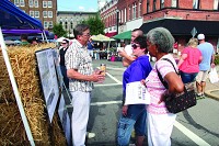 Consultant Ken Remenschneider, left, talks about the proposed plans for downtown Shelbyville at Downtown Shelby Days on Saturday. Staff photo by Andy Proffet