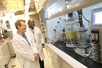 Professor Robert Kramer, Director, Energy Efficiency and Reliability Center at Purdue University Calumet, in foreground, and assistant Raloh Branch, an electrical engineering student at PUC, stand near a bioreactor that they are seeking to patent. Kramer reeived a patent in 2012 for his design of a multipurpose coal plant for synthetic fuel production. Purdue is 16th in the world in patents. Staff photo by John Luke