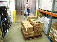 William Ziegler stores fresh produce in a walk-in cooler in Food Finders Food Bank. Food pantries expect increased need as a result of changes in SNAP eligibility. File photo/Journal &amp; Courier