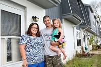 Amy and Craig Roupe, along with their 2-year-old daugter Lilly, pose for a portrait outside their Vinton Woods apartment. Kelly Lafferty Gerber | Kokomo Tribune