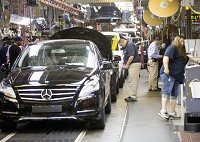 Workers stand next to the Mercedes-Benz R-Class production line at AM General&rsquo;s Commercial Assembly Plant in Mishawaka. The luxury car went into full production this summer after Mercedes announced in January it would be moving its R-Class manufacturing from Tuscaloosa, Ala., to Mishawaka. SBT Photo/BECKY MALEWITZ