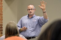 Eric Howard, founder and CEO of Outreach Inc., talks about youth homelessness during the Youth Worker Cafe meeting Tuesday at Family Service Society, Inc. "You guys are literally on the front lines," Howard said. Staff Photo/Jeff Morehead