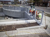 Construction workers install a railing at the Liberty Pass canal in downtown Muncie Thursday, Oct. 8, 2015. Photo: Jordan Kartholl/The Star Press 