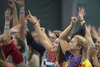Sam Watts (rear) and Libby Jefferis cheer during the IU Dance Marathon Saturday. The annual event attracts thousands of participants and is a fundraiser for Riley Hospital for Children. Staff photo by David Snodgress