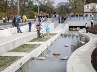 Dozens of community members and city workers came to the Liberty Pass canal dedication on Thursday at the corner of North Gilbert and West Liberty Street. The canal is a decorative feature for the project to move stormwater from downtown. (Photo: Corey Ohlenkamp/The Star Press)