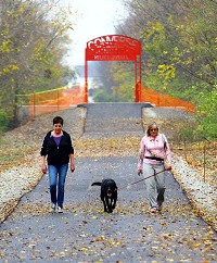 Julie Bossler and Lori Watson along with Joe walk the Converse Junction Trail on Nov. 5, 2015. Staff photo by Tim Bath