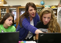 Natalie Guest helps Northwestern ninth graders Kaitlin Perry (left) and Grace Guerre with citing sources during their honors biology class at Northwestern High School on Wednesday, Nov. 4, 2015. Kelly Lafferty Gerber | Kokomo Tribune