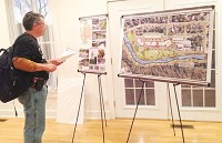 Blake Cromwell takes in a concept board of what type of development could come to the former Keller Manufacturing Co. site at Thursday night's unveiling at the First State Office Building in downtown Corydon. Photo by Alan Stewart