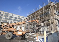 Workers from Ziolkowski Construction do some brick work to the parapet area at the former Studebaker factory building Monday in South Bend. SBT Photo/GREG SWIERCZ