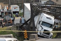 PAOLI -- The historic bridge on South Gospel Street in Paoli collapsed Friday afternoon when the driver of a semi-truck and trailer attempted to cross it from the south. Photo by Valerie Moon