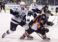 Evansville's Mark Anthoine (34) takes down Missouri's Sebastien Sylvestre (81) during their game at the Ford Center Wednesday night. The Mavericks beat the IceMen 3-0. Staff photo by Denny Simmons