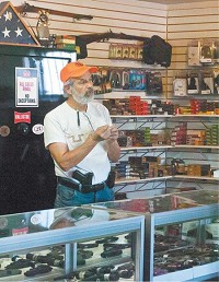 Mike Hatfield, owner of Phoenix Guns, waits behind the counter to help customers Thursday, Jan. 7, 2016. Ben Skirvin | The Republic