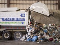 Blue bags containing recyclable material are dumped onto the floor of East Central Recycling in Muncie to be separated from other trash and recycled.(Photo: Corey Ohlenkamp/The Star Press)