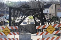 Orange County residents are hoping this 1880 iron bridge can be restored. It was damaged when the driver of a semi-tractor and trailer attempted to cross it on Christmas Day, disregarding the posted weight limit. Staff photo by Garet Cobb