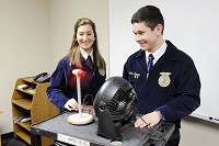Shenandoah students Sami DeLey and Brandon Barnes demonstrate the wind turbine model they built for their FFA project on the school system's wind turbine. Staff photo by Don Knight