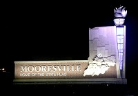 This is a view of the Mooresville entrance sign and torch on Thursday night south of town on Ind. 67. There is another entrance sign at Samuel Moore Parkwayto the north of town and a torch obelisk at Ind. 67 and Indiana Street. Staff photo by Brian Culp