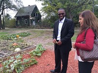 The Rev. Curtis Whittaker, of Progressive Community Church, speaks with Archana Gupta, of Dyer, in October at the church's community garden. Gary was one of just 27 cities nationwide chosen for a federal urban agriculture program last week, which could lead to more community gardens in Gary like the one at the church. Staff photo by Lauri Harvey Keagle