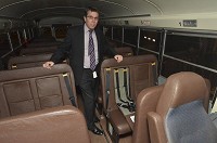 Vigo County School Corp. facilities director Franklin Fennel stands in a bus for special needs students. The bus has two sizes of harness for passengers, including small ones contained inside the regular seats. Staff photo by Jim Avelis