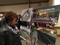 Yvonne Thompson looks at artists' renderings of the Kitselman Pure Energy Park Thursday in the Horizon Convention Center. Staff photo by Keith Roysdon